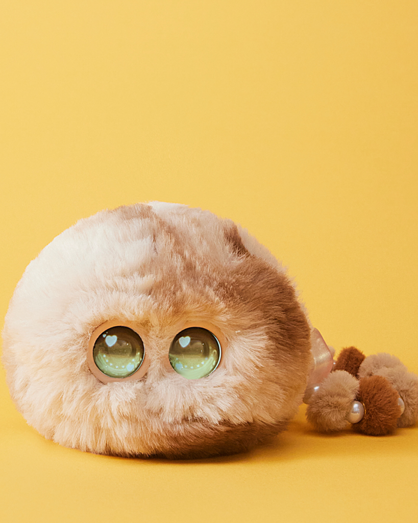Fuzozo Shanghai Luobo fluffy puffball AI pet with glowing green eyes and heart reflections – official product photo 2026